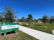 Ashton Trailhead sign with a paved trail path into the green grassy area at 5736 Ashton Lake Dr, Sarasota, FL 34231