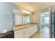 Double-sink bathroom with granite counters and natural light, adjacent to the main bedroom at 6125 35Th E Ct, Bradenton, FL 34203