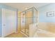 Bathroom with a tub and a glass enclosed shower, and neutral walls at 6125 35Th E Ct, Bradenton, FL 34203