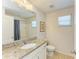 Bathroom featuring granite countertop, mirror, and shower with gray tiling at 6125 35Th E Ct, Bradenton, FL 34203