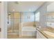 Bright bathroom features a shower, tub, and granite countertop with double sinks at 6125 35Th E Ct, Bradenton, FL 34203