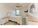 Bedroom with neutral tones, wood furniture, and a ceiling fan at 6125 35Th E Ct, Bradenton, FL 34203