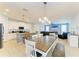Open floorplan kitchen and dining area bathed in light with pendant lighting at 6125 35Th E Ct, Bradenton, FL 34203