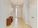 Bright foyer with neutral tones, tile flooring, a storage cabinet, and a decorative chandelier at 6125 35Th E Ct, Bradenton, FL 34203