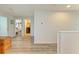 Hallway features hard surface floors, neutral paint, and views of the laundry room and bedroom at 6125 35Th E Ct, Bradenton, FL 34203