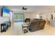 Bright living room with neutral tones, opening to a screened-in patio and backyard at 6125 35Th E Ct, Bradenton, FL 34203