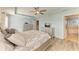 Main bedroom featuring wood-style flooring, neutral paint, ceiling fan, and access to en-suite bathroom at 6125 35Th E Ct, Bradenton, FL 34203