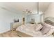 Comfortable bedroom features neutral paint, a tray ceiling, and a large window at 6125 35Th E Ct, Bradenton, FL 34203