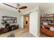 Stylish office with wood-look flooring, barn doors, and built-in shelving units for storage and decor at 6125 35Th E Ct, Bradenton, FL 34203