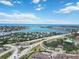 Expansive aerial view showcasing a coastal community, bay, roadways, and commercial areas under a partly cloudy sky at 672 White Pine Tree Rd # 57, Venice, FL 34285