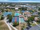 Aerial view of community facilities with tennis and shuffleboard courts near the pool, and buildings, parking at 672 White Pine Tree Rd # 57, Venice, FL 34285