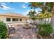 Charming courtyard with a brick patio, a central fountain, benches, mature trees, and a building in the background at 672 White Pine Tree Rd # 57, Venice, FL 34285