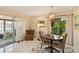 Dining area with a modern chandelier, access to lanai, and stylish décor at 672 White Pine Tree Rd # 57, Venice, FL 34285