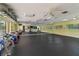 Spacious fitness center with large mirror, weights, exercise balls, and ceiling fans providing a modern and well-equipped workout area at 672 White Pine Tree Rd # 57, Venice, FL 34285