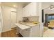 Kitchen featuring white appliances, marbled countertops, eat-in counter and ample storage cabinets at 672 White Pine Tree Rd # 57, Venice, FL 34285
