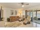 Comfortable living room with neutral tones, tile floors, and access to the screened lanai at 672 White Pine Tree Rd # 57, Venice, FL 34285