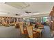 Inviting residents' lounge featuring comfortable seating, bookshelves, and plenty of natural light streaming through large windows at 672 White Pine Tree Rd # 57, Venice, FL 34285