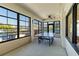 Enclosed patio with a ping pong table, a ceiling fan, and large windows providing ample natural light and view of landscaping at 672 White Pine Tree Rd # 57, Venice, FL 34285