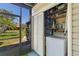 Enclosed back porch featuring a washer and dryer and view of the lawn at 672 White Pine Tree Rd # 57, Venice, FL 34285