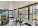Cozy sunroom featuring tile floors, comfortable seating, and large windows for natural light at 672 White Pine Tree Rd # 57, Venice, FL 34285