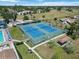 Overhead view of community tennis courts near the pool, showing the facility and the surrounding buildings and green space at 672 White Pine Tree Rd # 57, Venice, FL 34285