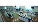 A decorated banquet hall featuring set tables with white chairs, black tablecloths, and hardwood floors at 6720 Northampton Pl, Bradenton, FL 34207