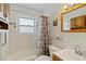 Bright bathroom with tiled shower/tub, updated vanity, and nautical decor at 6720 Northampton Pl, Bradenton, FL 34207