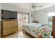 Cozy bedroom with flamingo bedding, wood furniture, and natural light from window at 6720 Northampton Pl, Bradenton, FL 34207