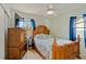 Comfortable bedroom featuring a wooden bed frame and dresser at 6720 Northampton Pl, Bradenton, FL 34207