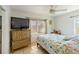 Cozy bedroom with flamingo bedding, wood furniture, and natural light from window at 6720 Northampton Pl, Bradenton, FL 34207
