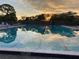 Beautiful shot of the community pool, reflecting a colorful sky at dusk at 6720 Northampton Pl, Bradenton, FL 34207
