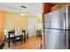 Eat in kitchen with wood floors, stainless steel refrigerator and ceiling fan at 6720 Northampton Pl, Bradenton, FL 34207