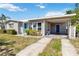Single-story home with carport and bright blue doors offers convenient parking and stylish curb appeal at 6720 Northampton Pl, Bradenton, FL 34207