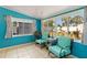 Bright Florida room with turquoise walls, tile flooring, and backyard views at 6720 Northampton Pl, Bradenton, FL 34207