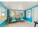 Bright Florida room with turquoise walls, tile flooring, and backyard views at 6720 Northampton Pl, Bradenton, FL 34207
