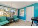 Bright Florida room with turquoise walls, tile flooring, and backyard views at 6720 Northampton Pl, Bradenton, FL 34207