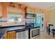 Kitchen with tile countertops, stainless steel appliances and view to the dining area at 6720 Northampton Pl, Bradenton, FL 34207