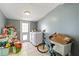 Utility room with tiled floor, modern washer and dryer, access door to the backyard, and extra storage space at 6720 Northampton Pl, Bradenton, FL 34207