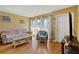 Cozy living room featuring wood floors, natural light, and comfortable seating at 6720 Northampton Pl, Bradenton, FL 34207