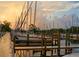 Boats docked in a marina with a wooden walkway under a beautiful sky at 6720 Northampton Pl, Bradenton, FL 34207