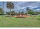 Community playground featuring multiple slides, swings, and climbing areas, surrounded by lush landscaping at 6720 Northampton Pl, Bradenton, FL 34207