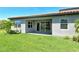View of the backyard featuring a covered patio and manicured lawn at 6800 Dunlin Ct, Sarasota, FL 34241