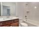 Bathroom featuring a vanity with dark wood cabinets, white sink, and shower-tub combo at 6800 Dunlin Ct, Sarasota, FL 34241