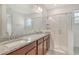 Bathroom features granite countertops, dual sinks and a glass shower at 6800 Dunlin Ct, Sarasota, FL 34241
