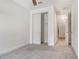 Bright, neutral bedroom features a closet with modern doors and attached bath at 6800 Dunlin Ct, Sarasota, FL 34241