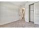 A cozy, neutral bedroom with closet access and open door to hall and bath at 6800 Dunlin Ct, Sarasota, FL 34241