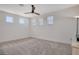 A bright bedroom featuring neutral carpet, a modern ceiling fan and multiple windows providing natural light at 6800 Dunlin Ct, Sarasota, FL 34241