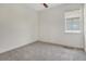 A simple bedroom with a ceiling fan, neutral carpet and natural light at 6800 Dunlin Ct, Sarasota, FL 34241