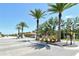 Gated community entrance with lush landscaping and palm trees, providing a welcoming and secure entry at 6800 Dunlin Ct, Sarasota, FL 34241