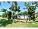 Well-manicured community entrance featuring a sign for 'Heron Landing' and lush surrounding greenery at 6800 Dunlin Ct, Sarasota, FL 34241